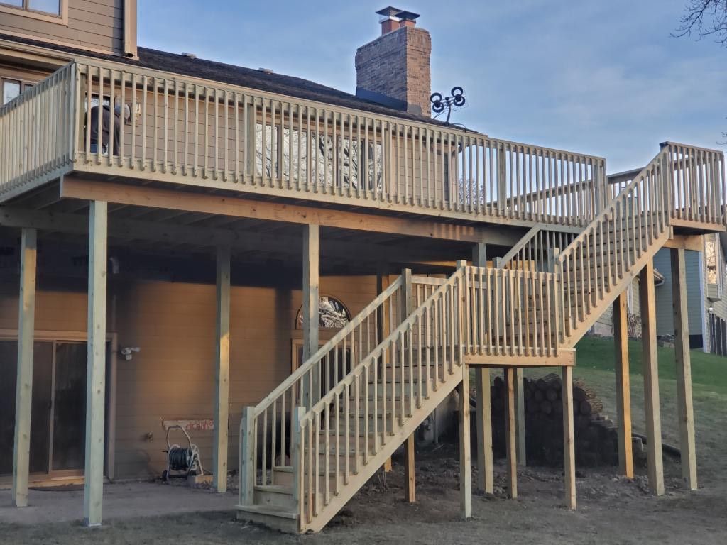 A wooden deck with stairs leading up to it