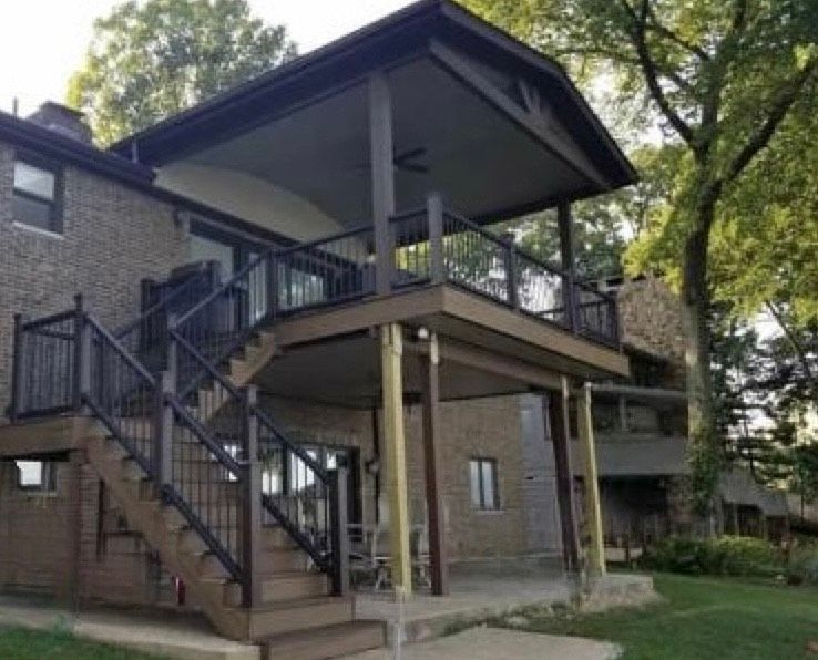 A house with a large deck and stairs leading up to it