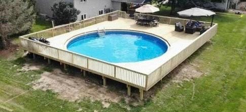 An aerial view of a large swimming pool surrounded by a wooden deck.