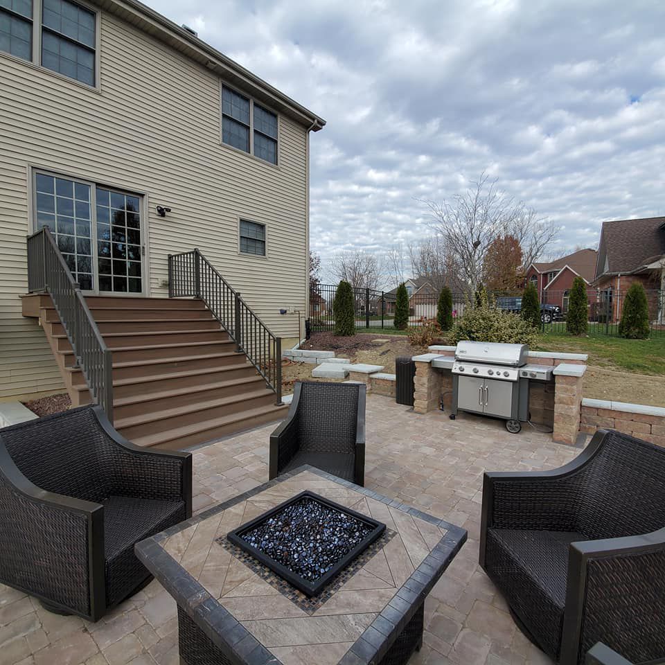 A patio with chairs and a fire pit