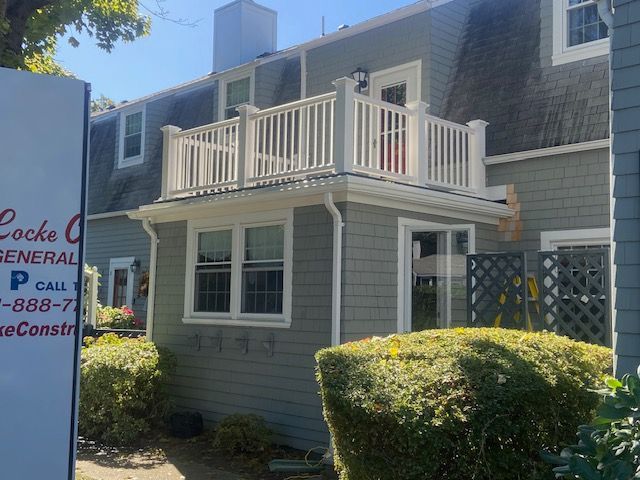 grey house with white railing 