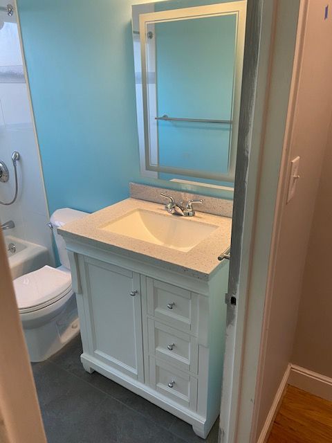 Sink and vanity with teal walls