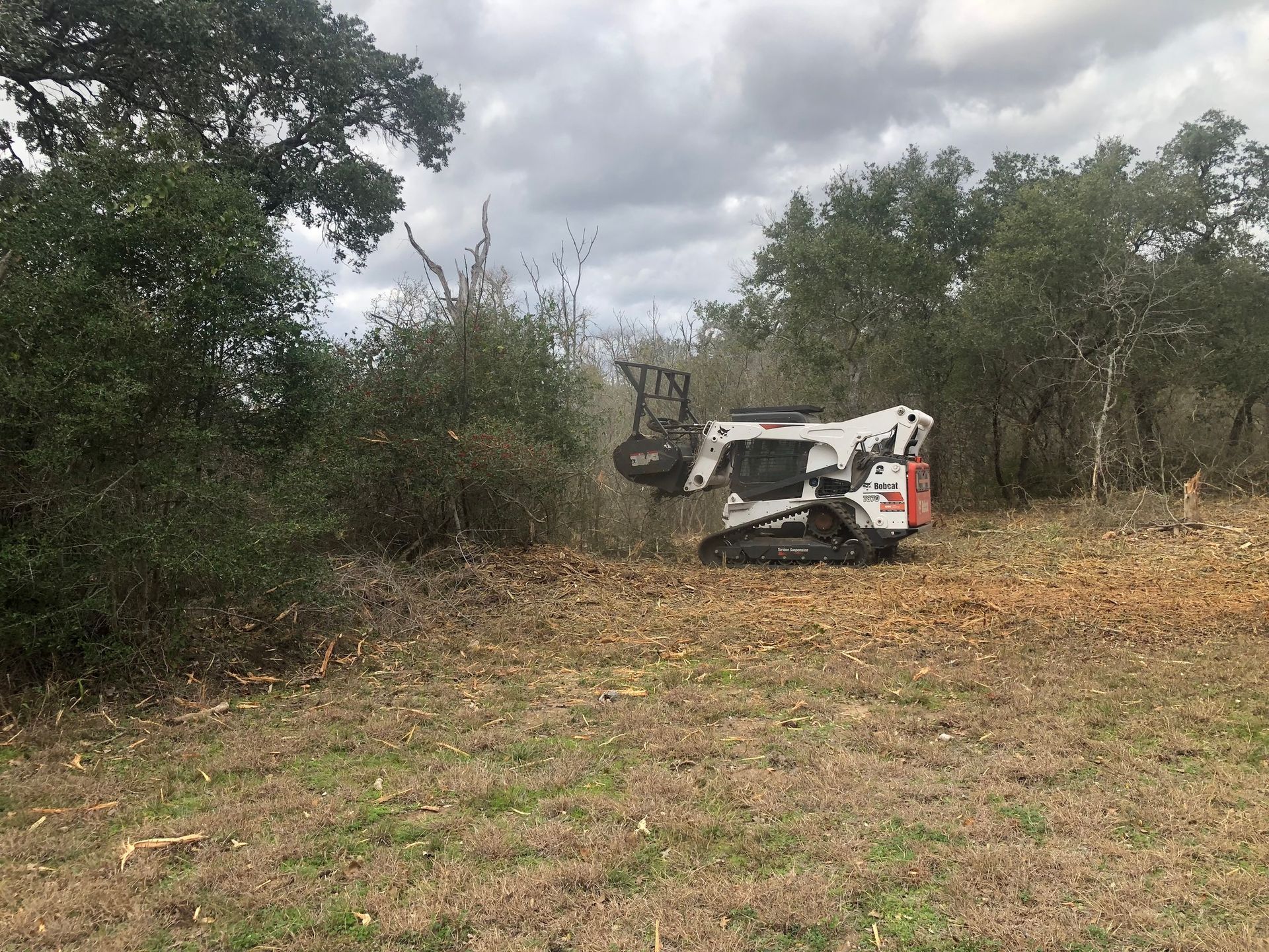A bulldozer is sitting in the middle of a field.
