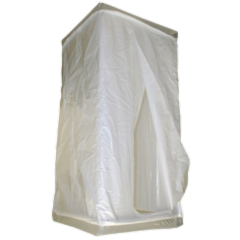 A tall, rectangular enclosure covered in white plastic sheeting; open doorway.