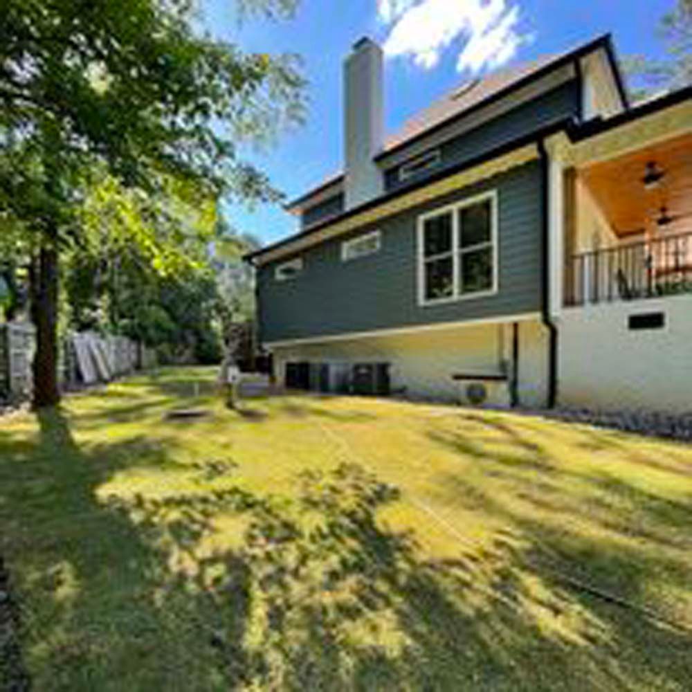 A large house with a large lawn in front of it.