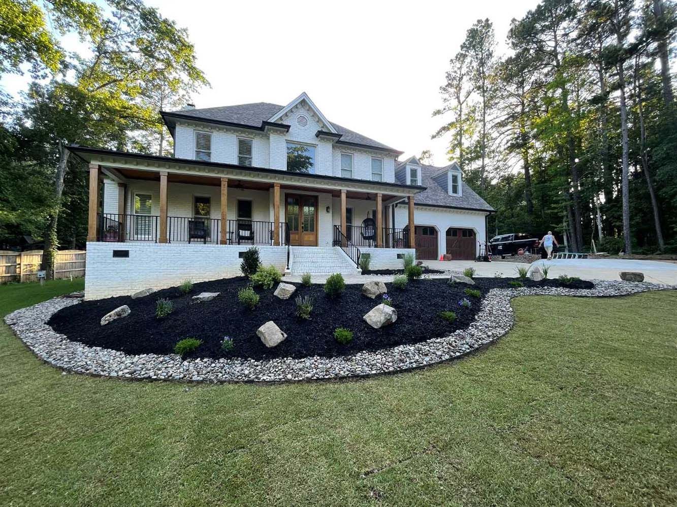 A large white house with a large lawn in front of it.