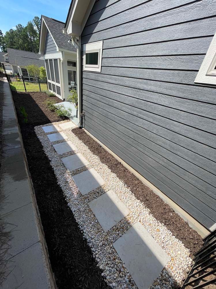 There is a walkway leading to the side of the house.