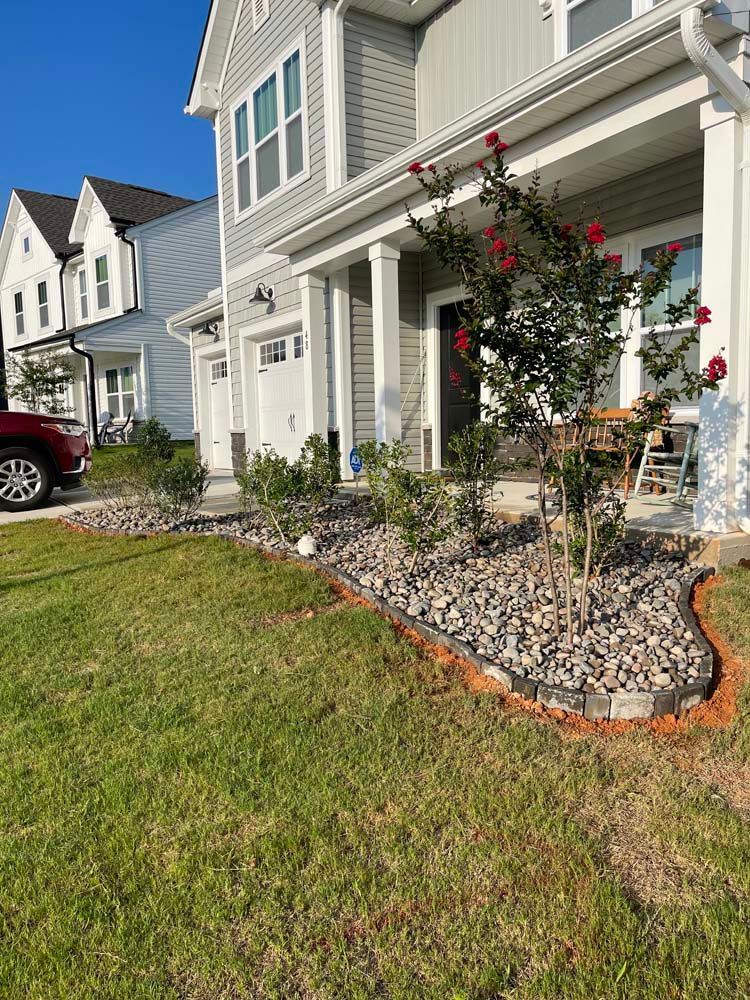 A house with a red car parked in front of it.