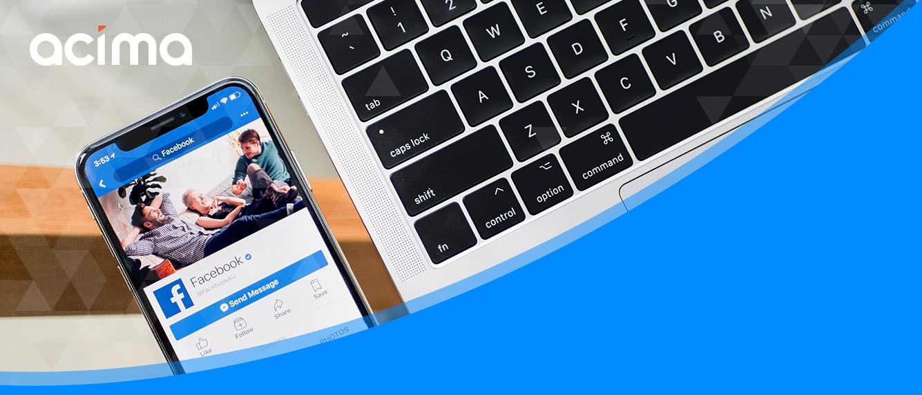 Acima app on a smartphone beside a laptop keyboard on a blue background
