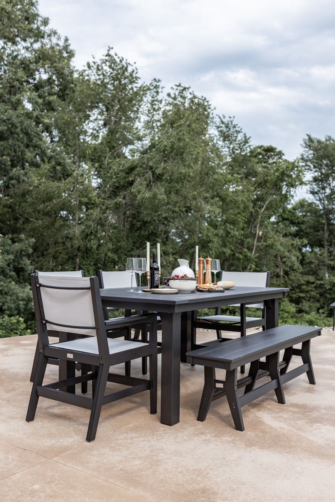 Homestead 44-by-72-inch recycled plastic patio dining table with black Mayhew Sling chairs in Lewisburg, Pennsylvania.