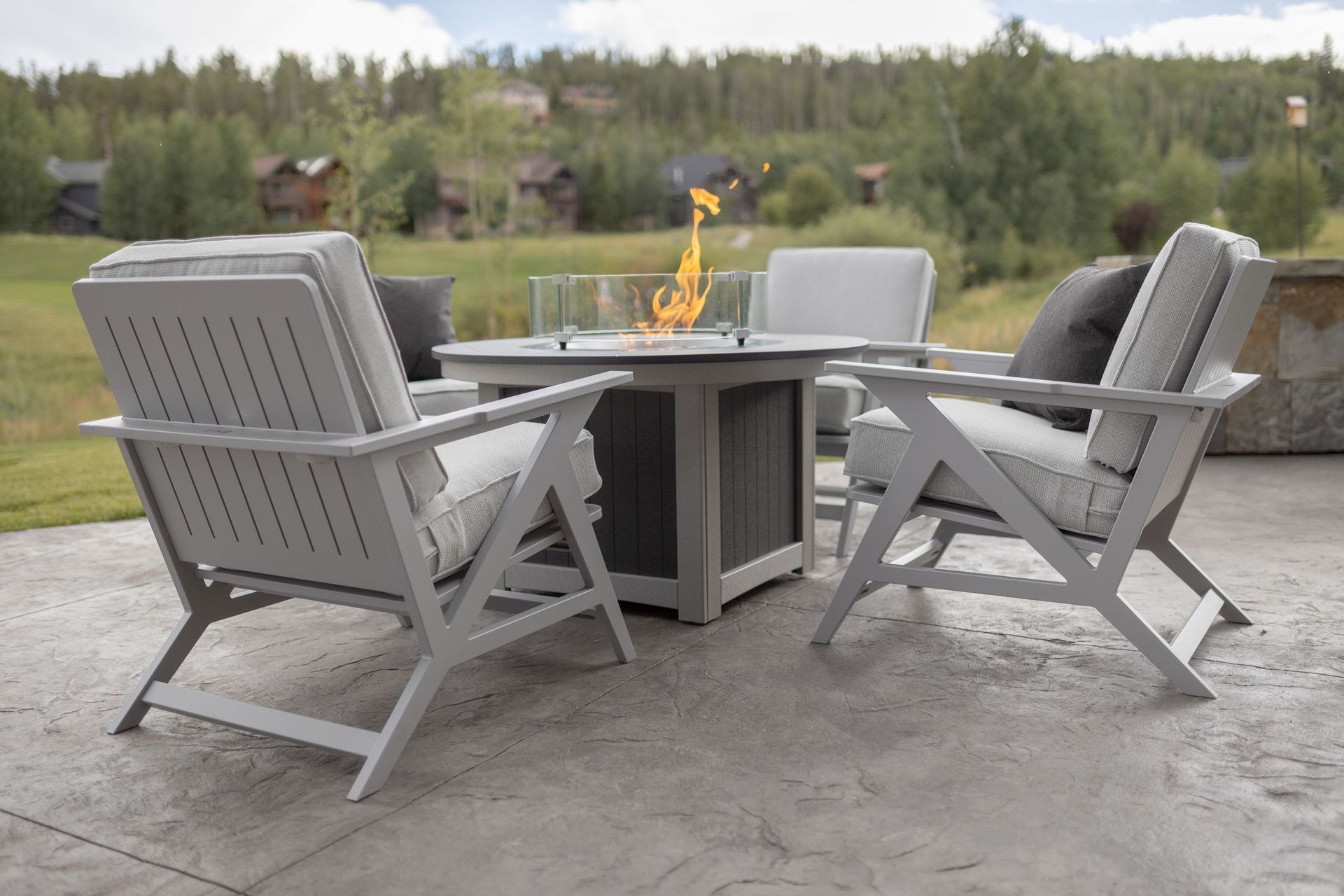 Donoma fire pit in Smoke Gray and Light Gray surrounded by Kinsley Lounge Chairs on a stylish outdoor patio in Lewisburg, Pennsylvania.