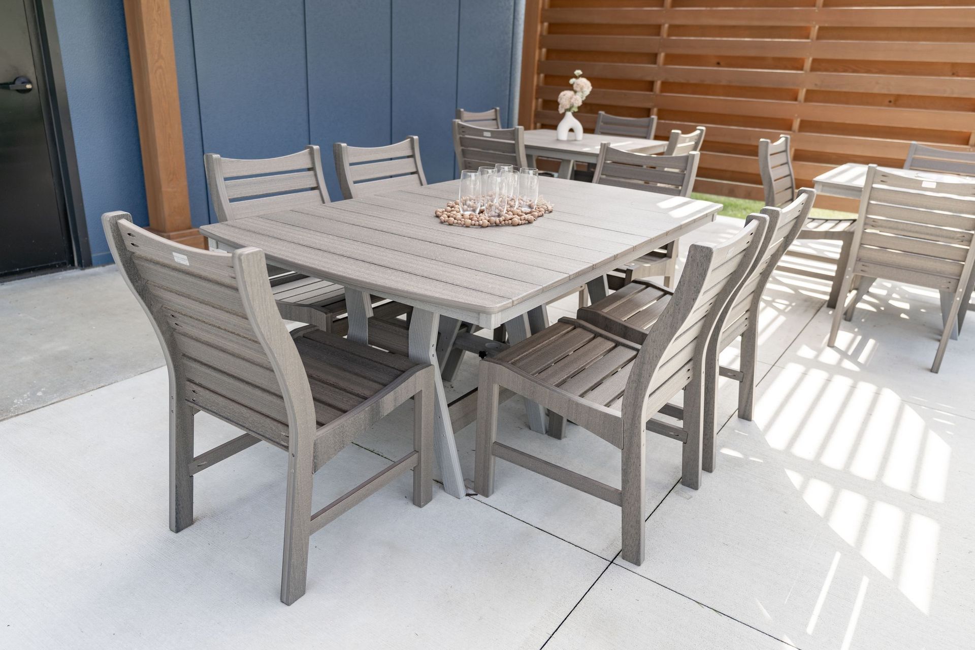 Outdoor Harbor dining table with Bristol chairs in Coastal Gray on Driftwood, made from recycled plastic.
