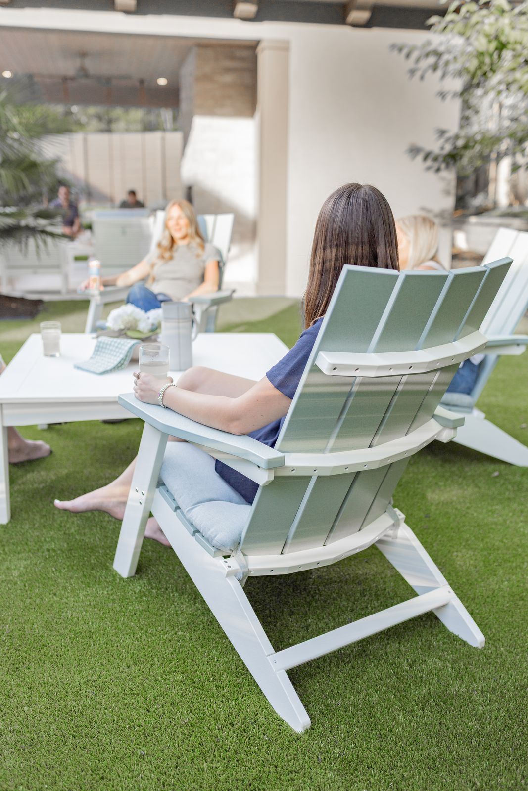 Back view of Seafoam on White recycled plastic Mayhew Stationary Adirondack chairs on a patio in Lewisburg, Pennsylvania.