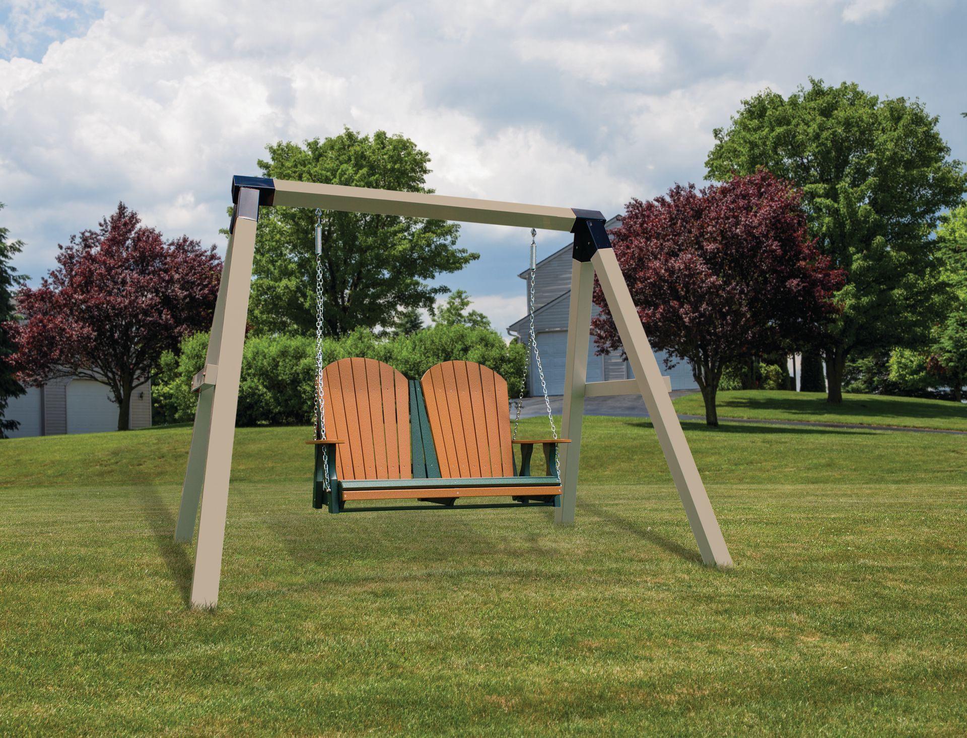 Swing set placed on a grassy lawn, with trees and a cloudy sky in the background.