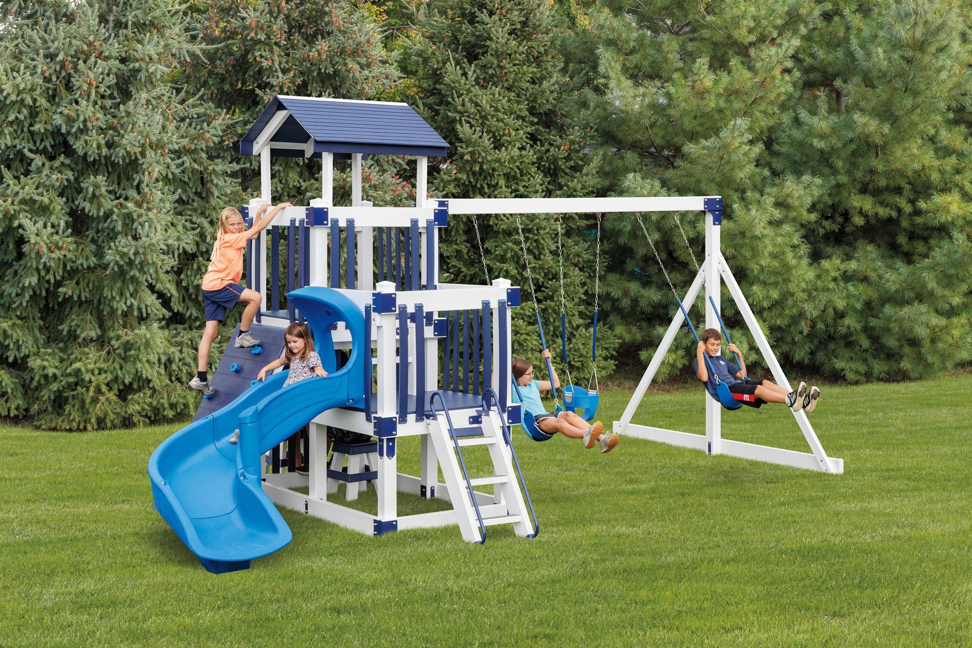 Playground with blue and white structure, slide, swings, and children playing on grass.