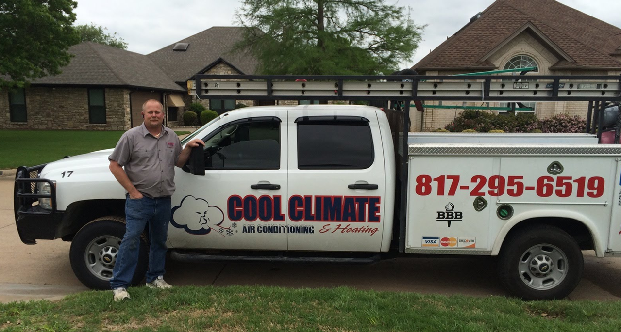 An air conditioning unit being serviced outdoors, with tools, hoses, and vacuum pump.