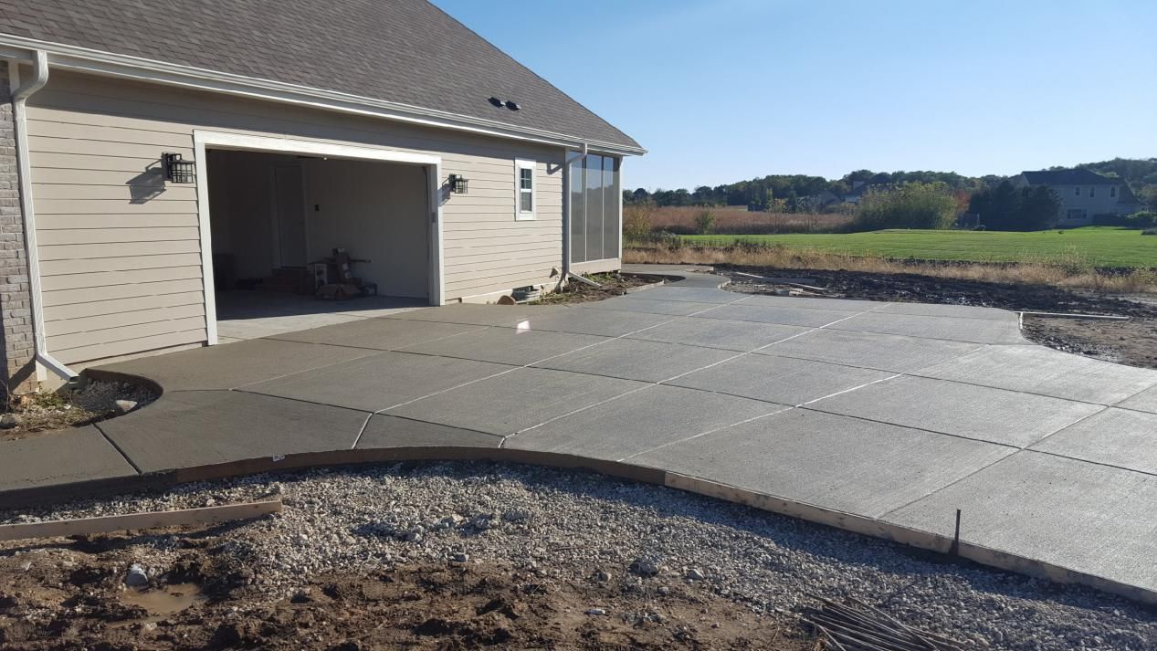 a concrete driveway is being built in front of a house