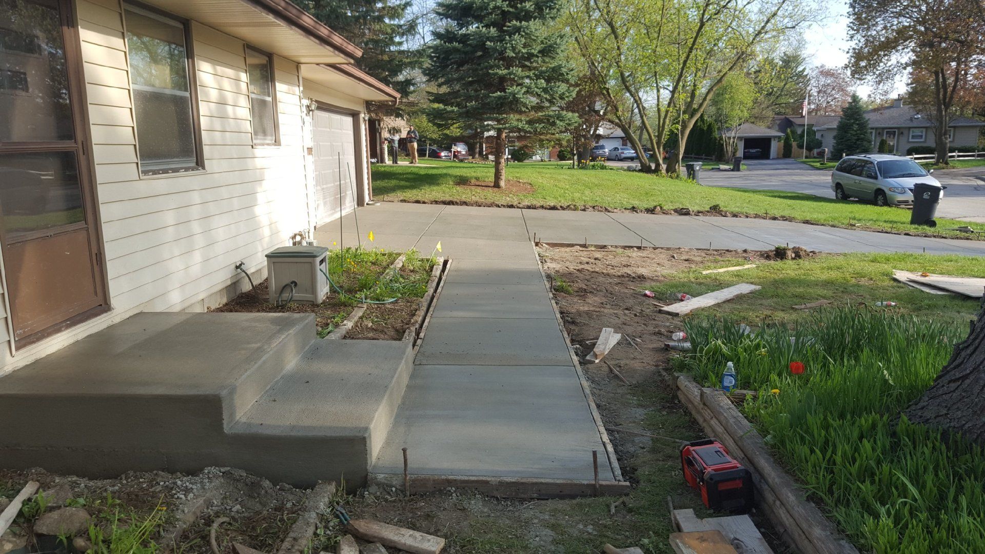 a concrete walkway is being built in front of a house