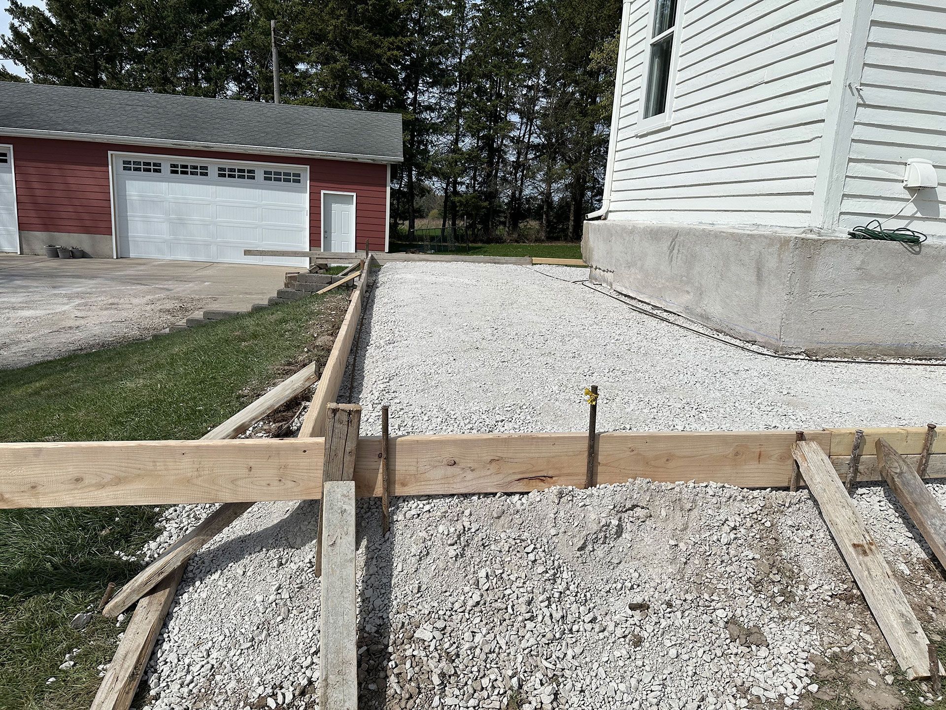 A driveway is being built in front of a house