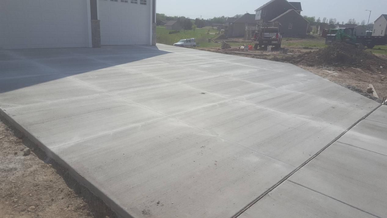 a concrete driveway is being built in front of a garage
