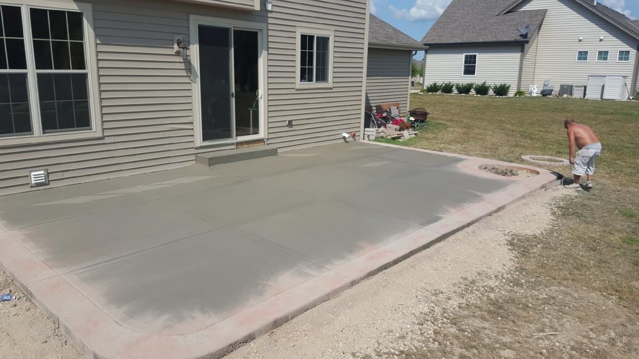 a man is working on a concrete patio