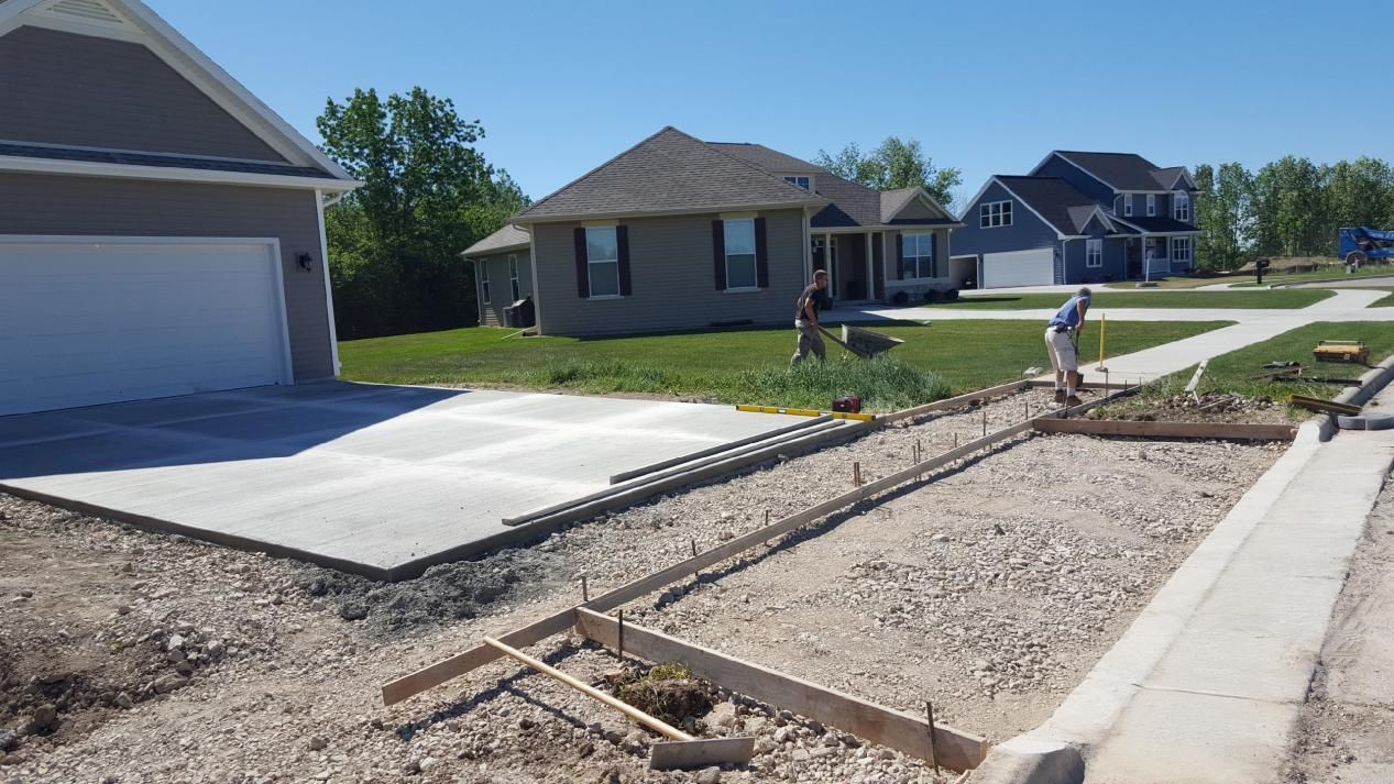 two men working on a concrete driveway and walkway