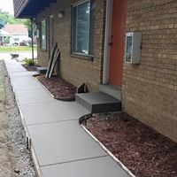 a walkway is being built in front of a brick building