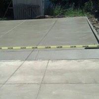 a newly-built concrete patio with a yellow tape
