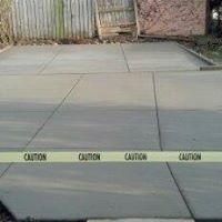 a concrete driveway near the fence