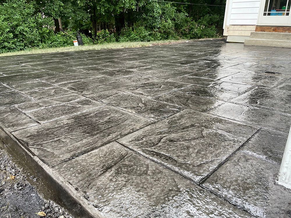 A close up of a concrete patio in front of a house.