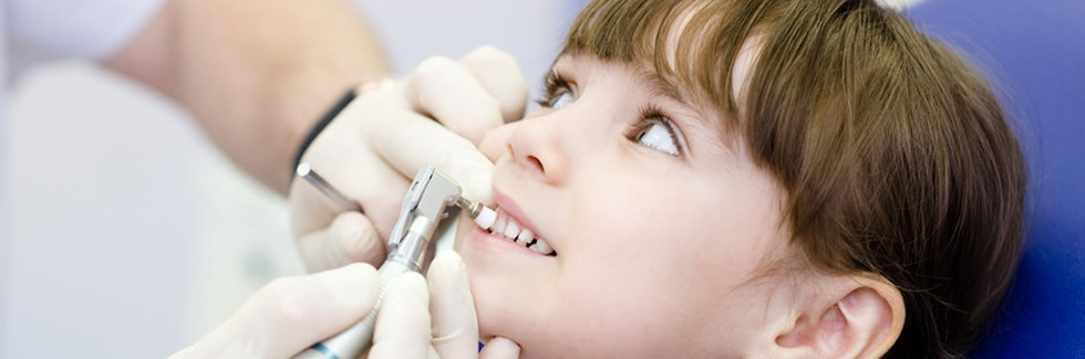Child receiving a teeth cleaning