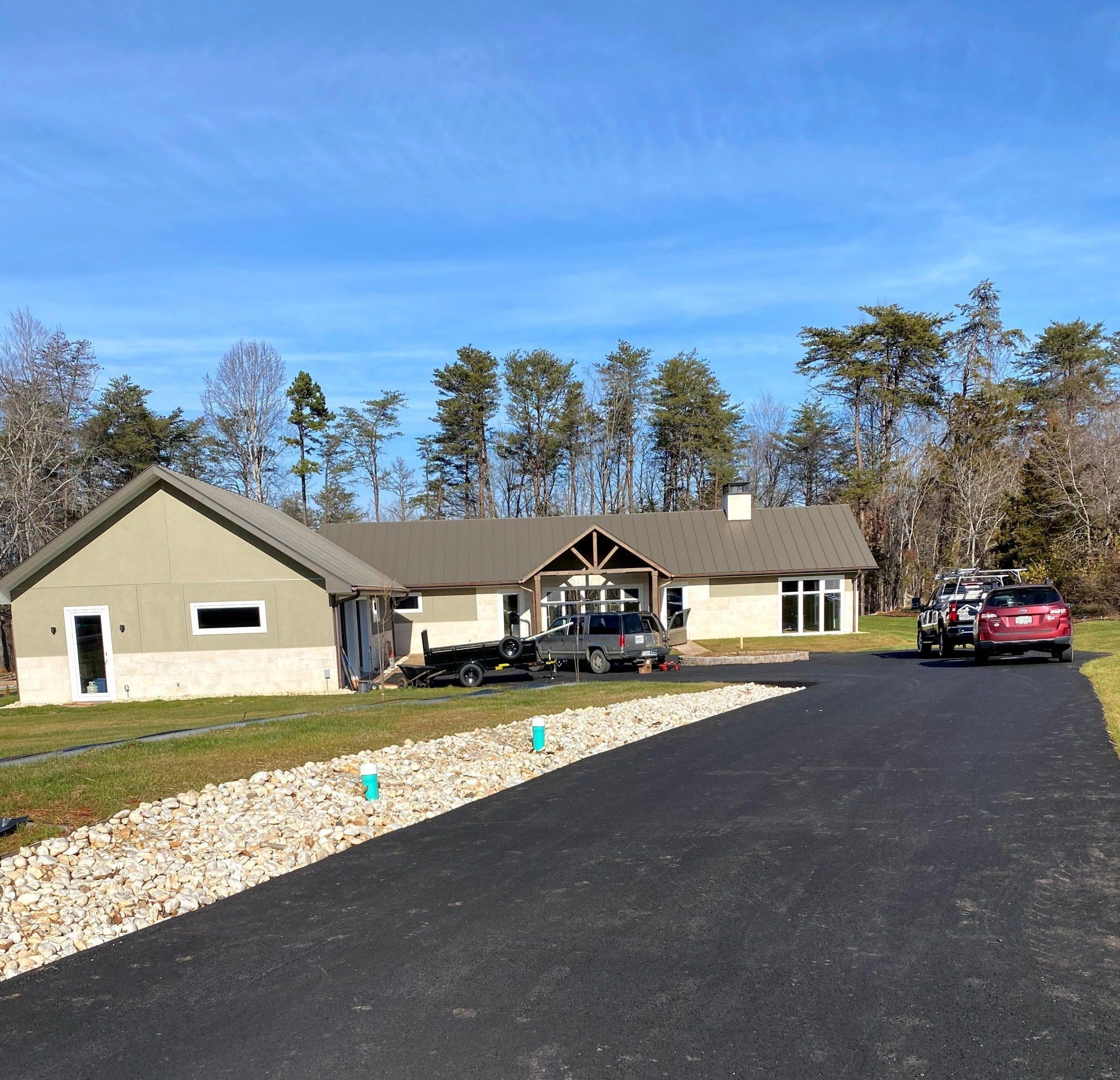 A couple of cars are parked in front of a house