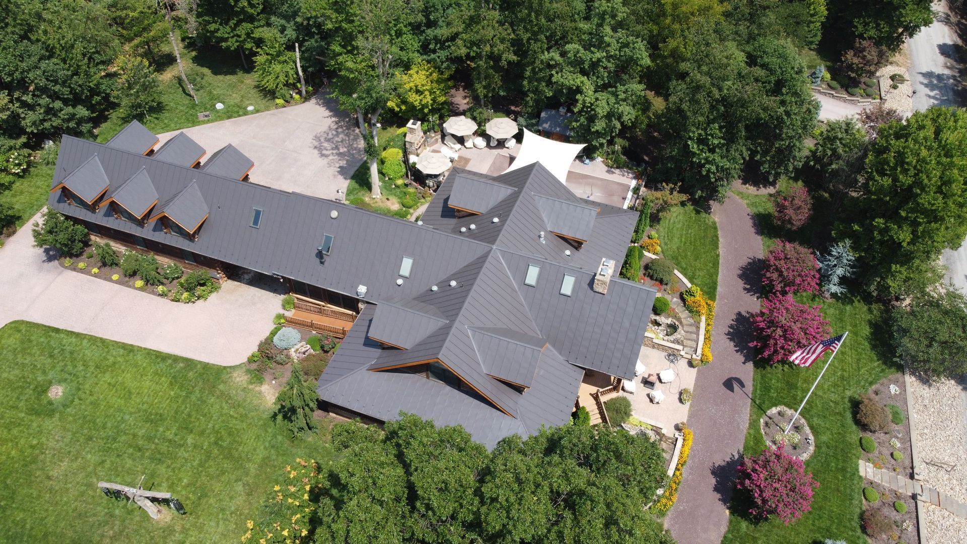 An aerial view of a large house surrounded by trees.
