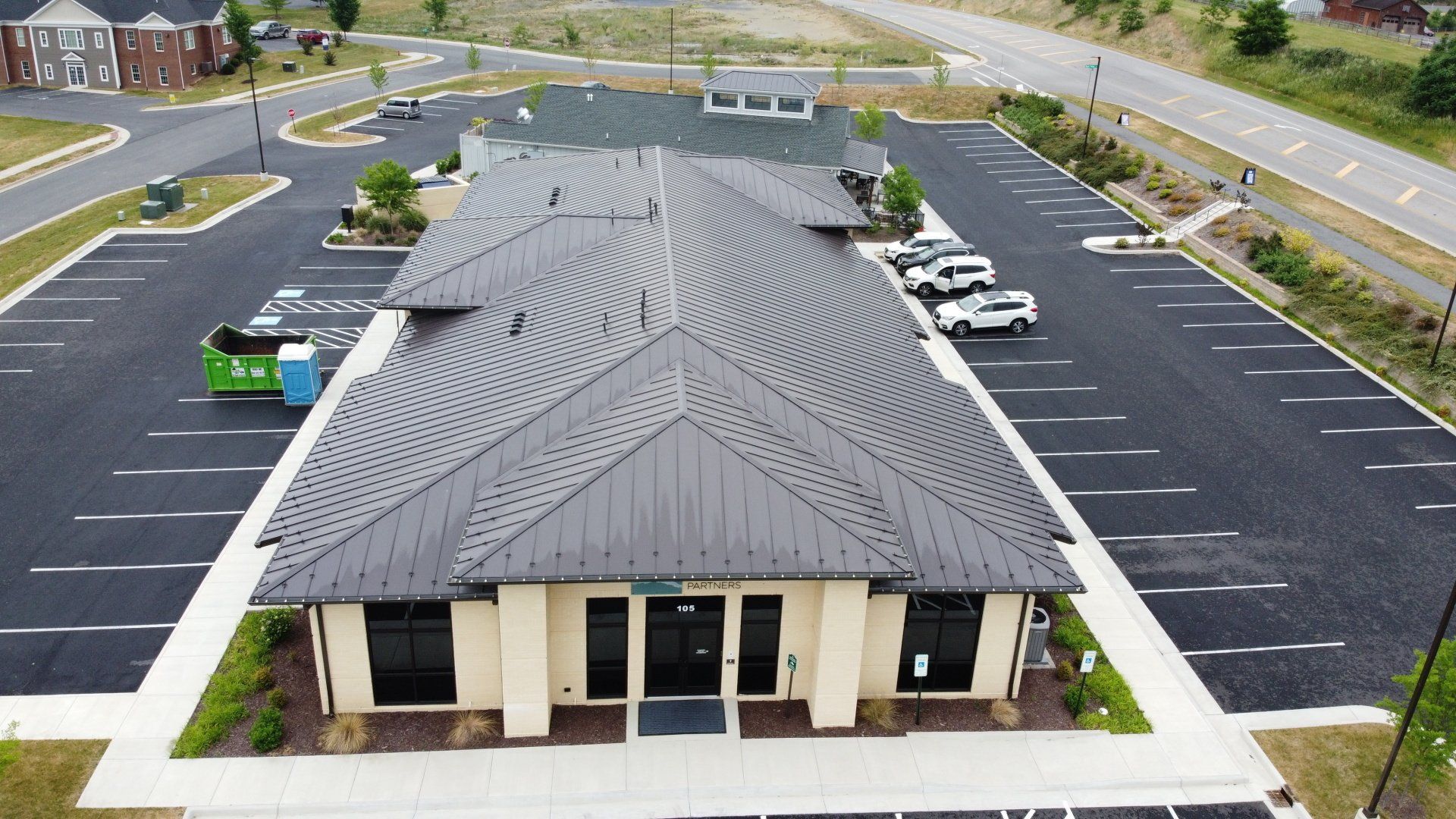 An aerial view of a building with a parking lot in front of it