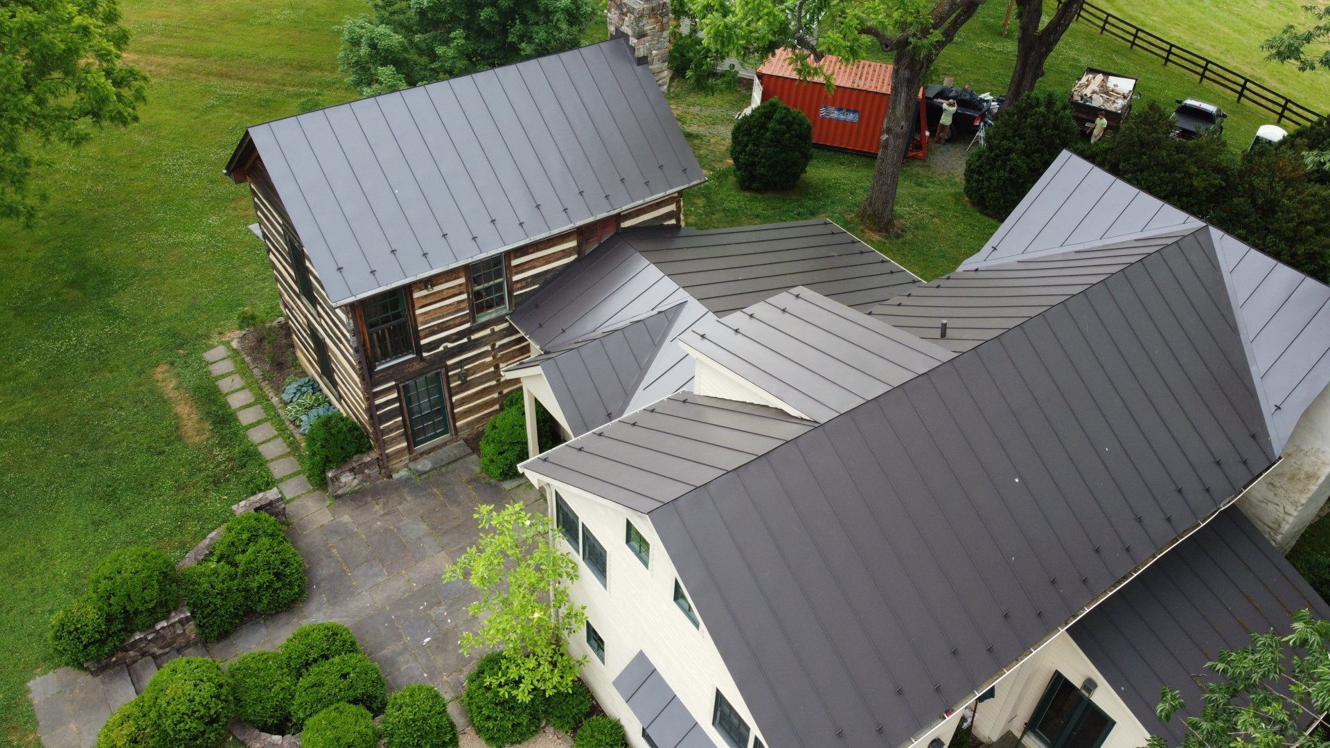 An aerial view of a house with a metal roof.