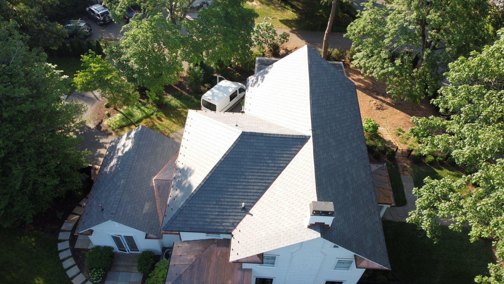 An aerial view of a large house surrounded by trees.