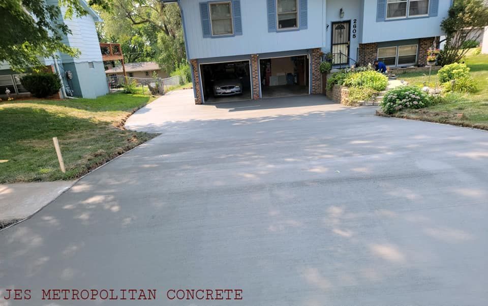 A car is parked in a driveway in front of a house