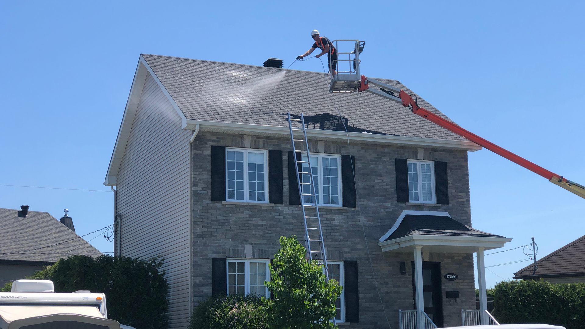 A man is working on the roof of a house.