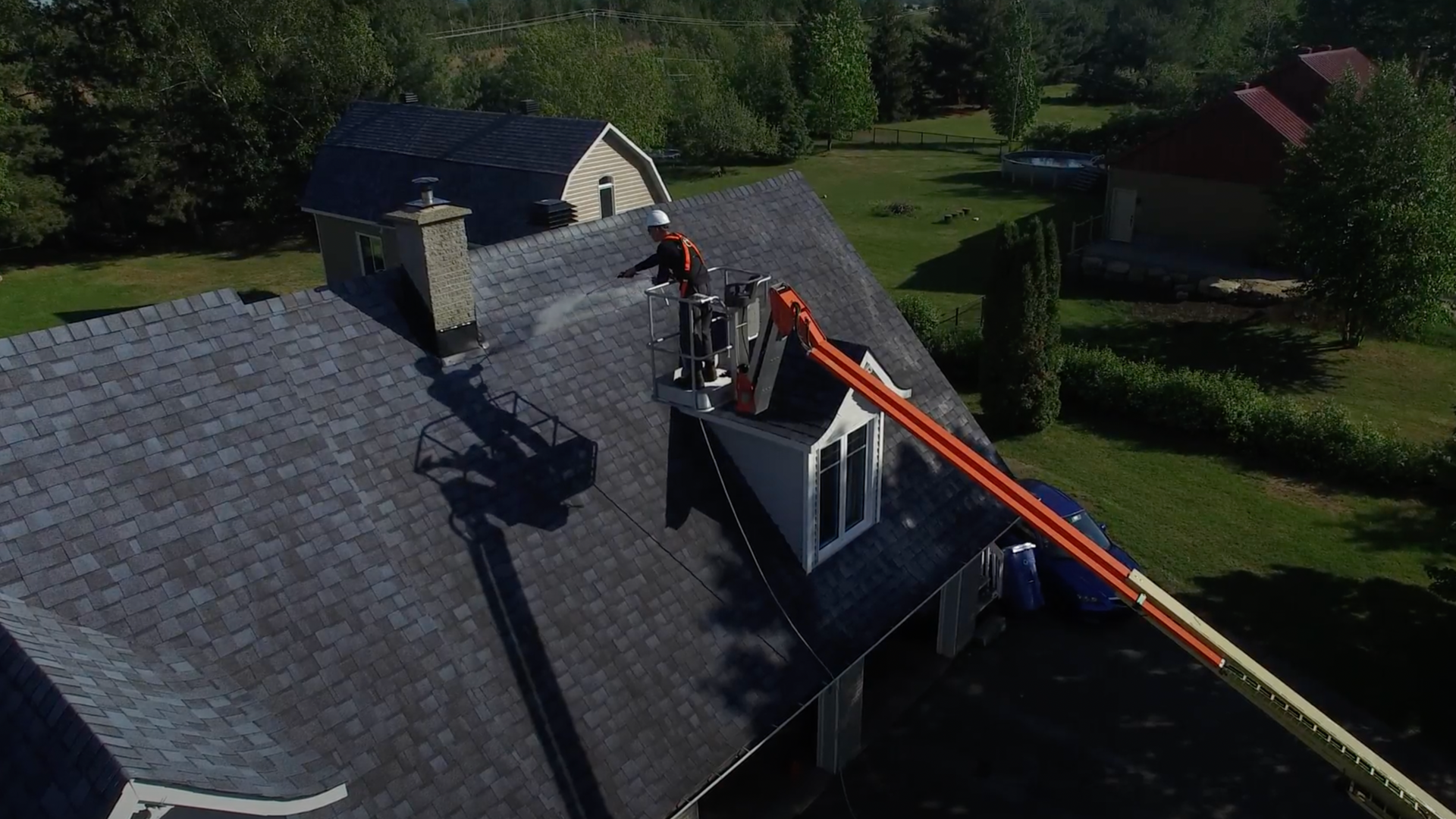 An aerial view of a house with a crane on the roof.