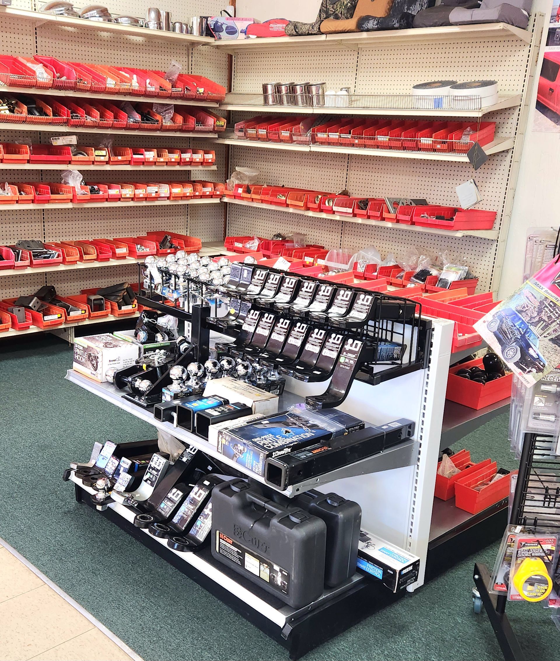 A store shelf filled with lots of tools and boxes.