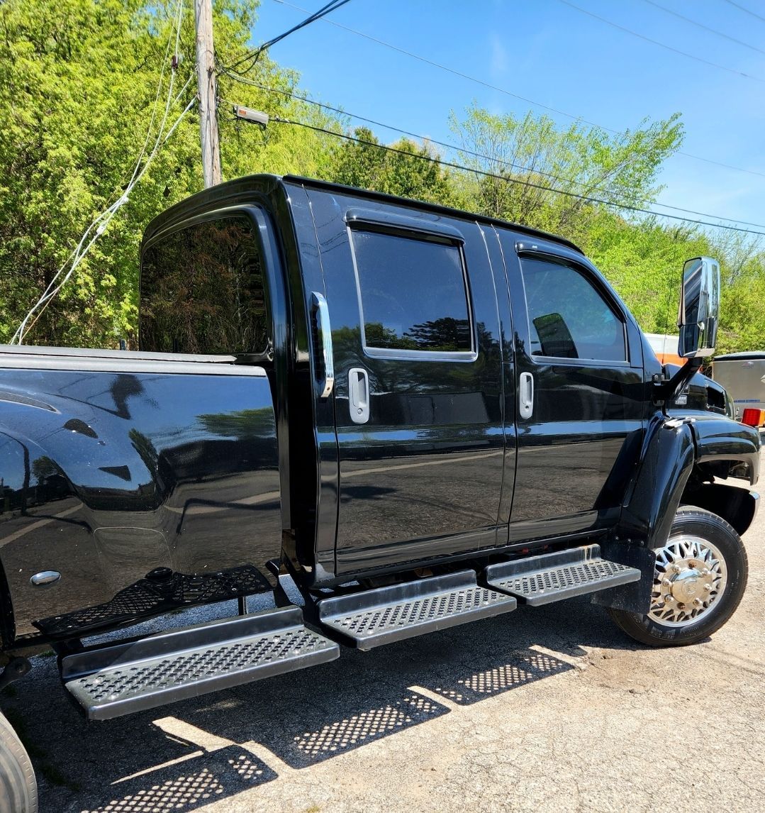 A black truck is parked in a parking lot
