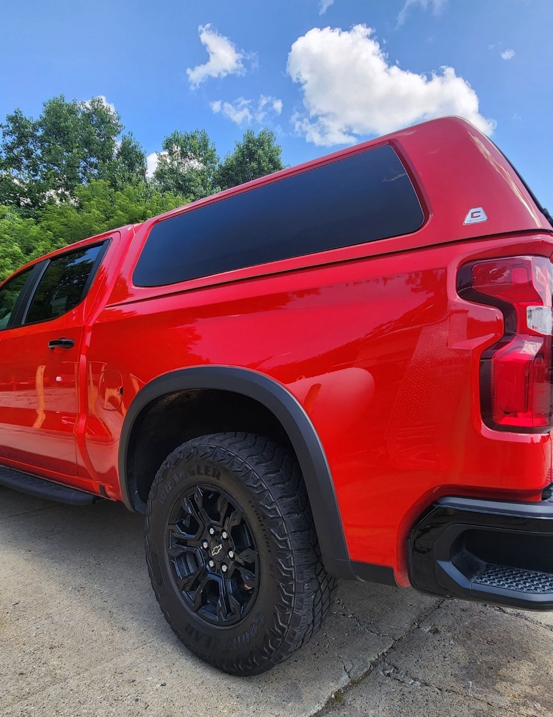 A red truck is parked on the side of the road