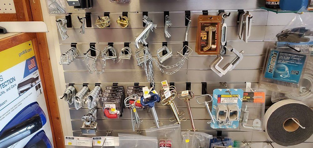 A bunch of tools are hanging on a wall in a store.