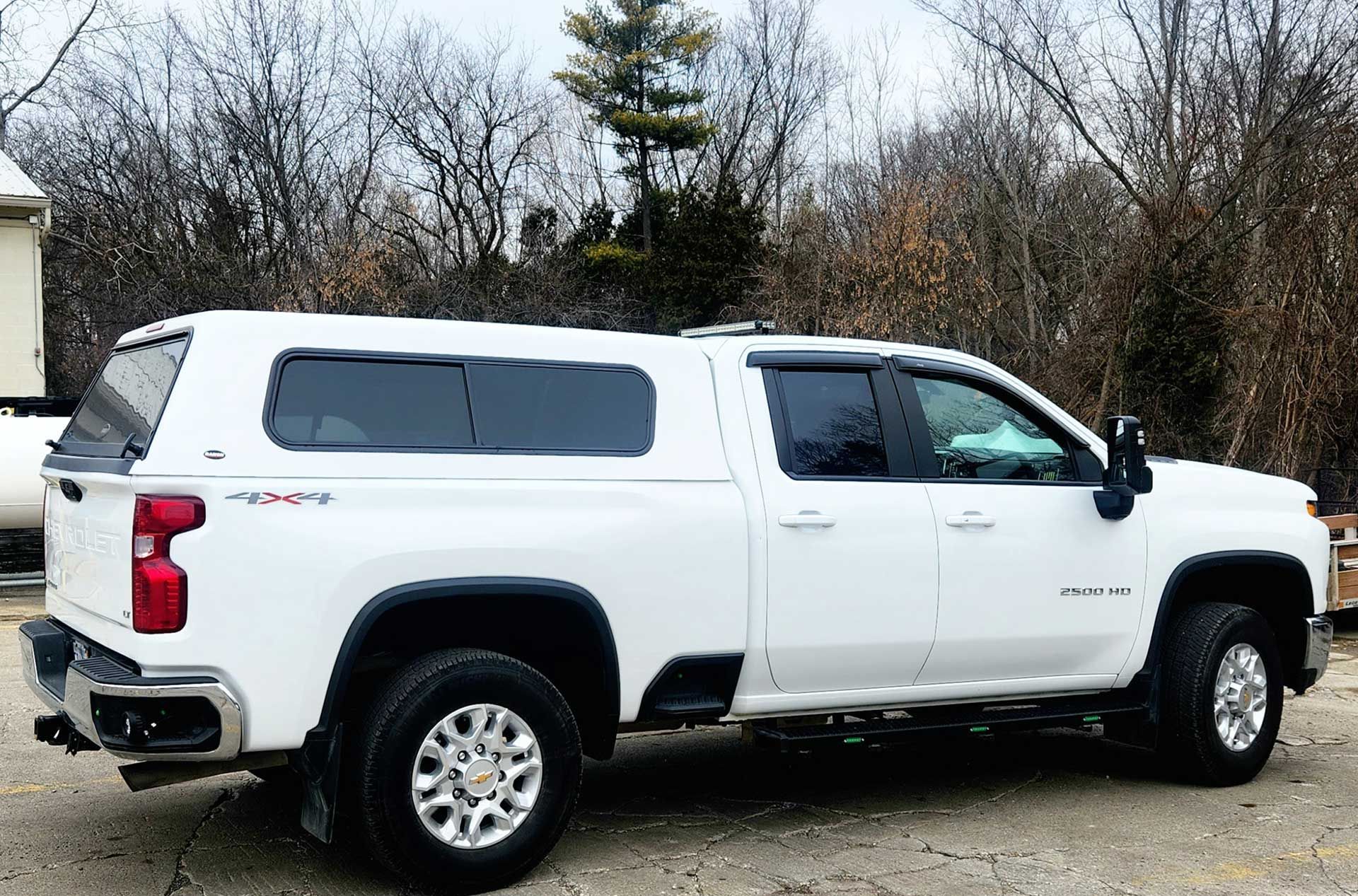white Chevrolet pickup truck with bed cover