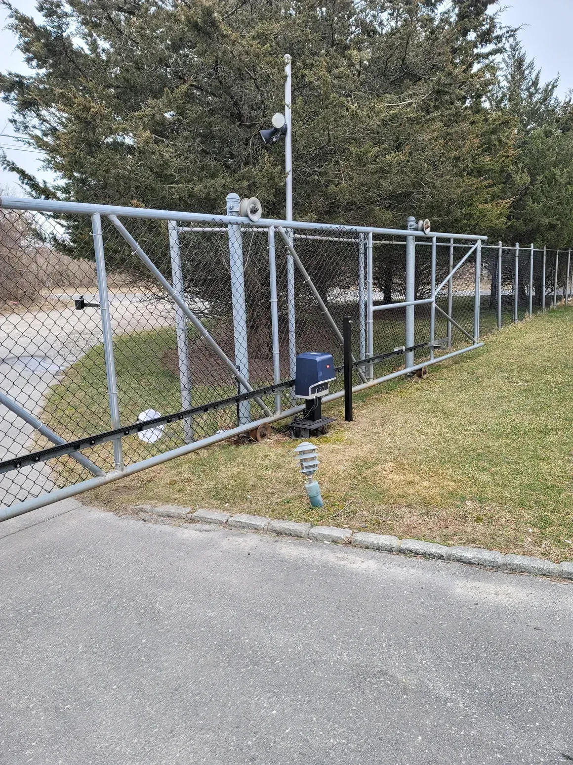A chain link fence with a gate and a sliding gate.