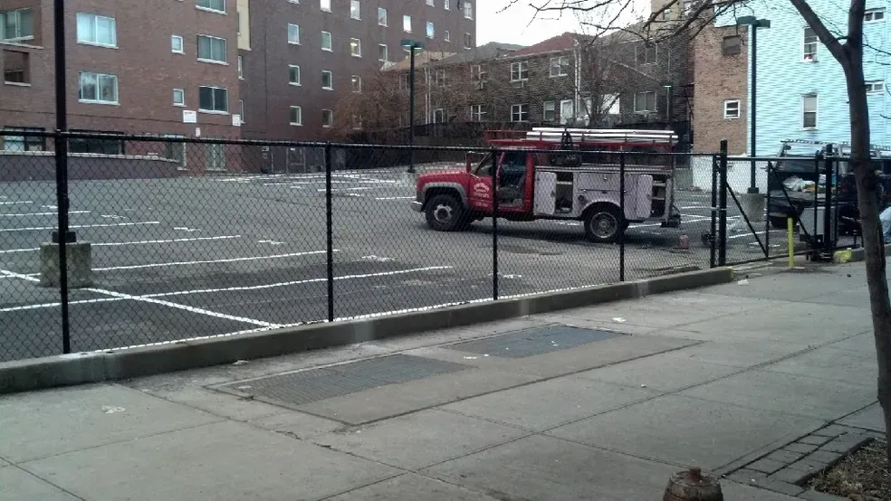 A red fire truck is parked in a parking lot