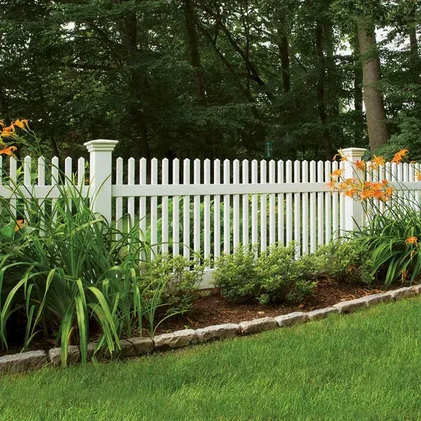 A white picket fence surrounds a lush green yard
