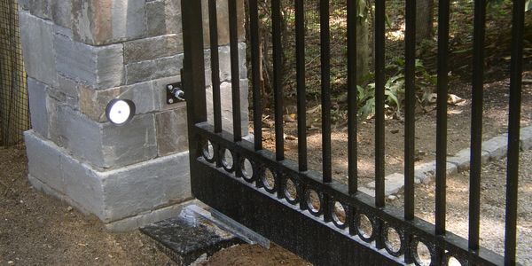 A close up of a gate with a light on it.