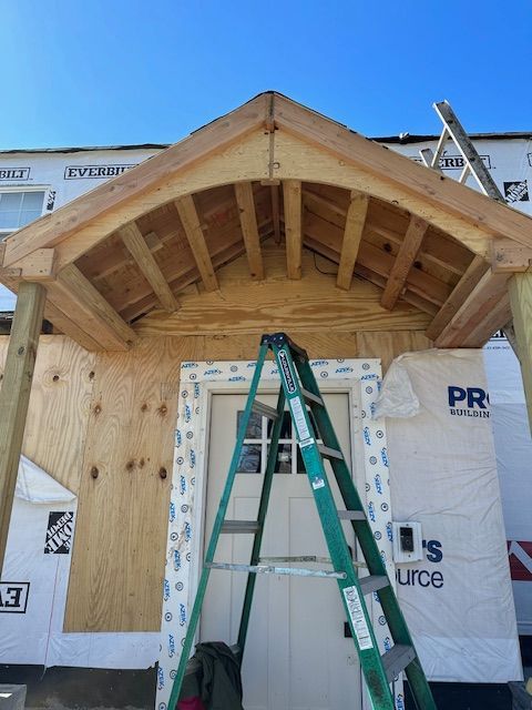 A ladder is sitting in front of a building that says 'us source' on it