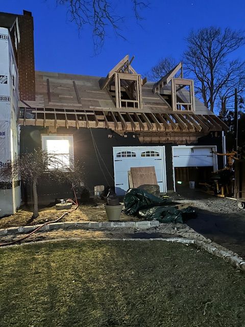 A house under construction with a garage underneath it.